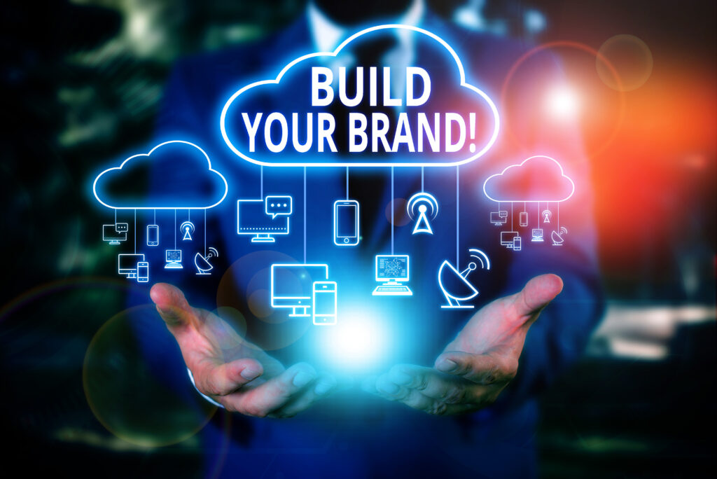 Writing note showing Build Your Brand. Business concept for creates or improves customers knowledge and opinions of product Male wear formal work suit presenting presentation smart device