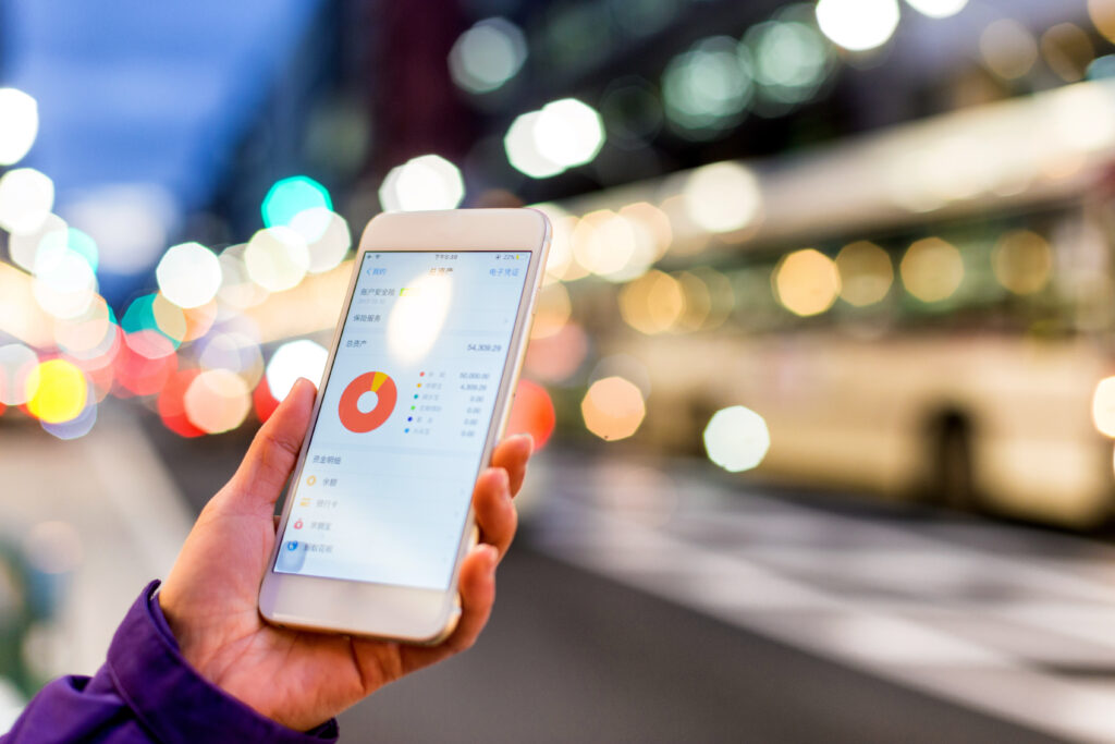 woman checks stock market in mobile phone